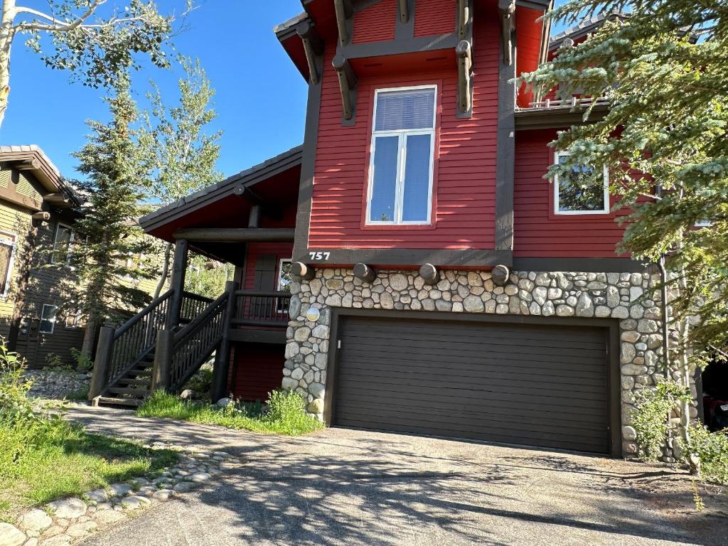 a red house with a garage in the driveway at Snowcreek V #757 condo in Mammoth Lakes