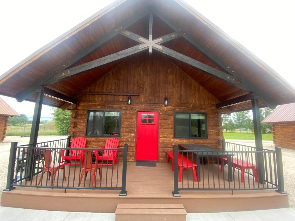 a cabin with red chairs and a red door at SkyWater Cabins in Hamilton