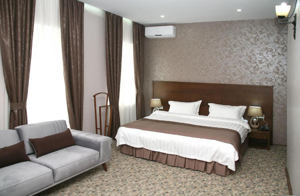 a hotel room with two beds and two lamps at Old Metekhi Hotel in Tbilisi City
