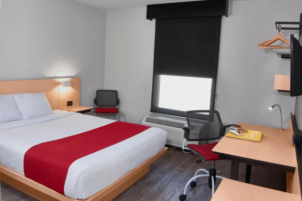 Postel nebo postele na pokoji v ubytování City Express by Marriott Leon