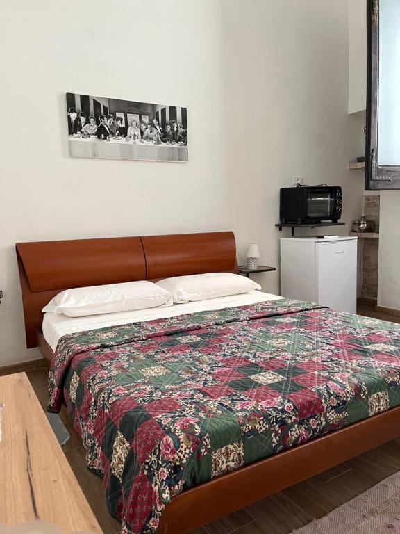 a bedroom with a bed with a quilt on it at B&B Il Panorama in Torre Maggiore