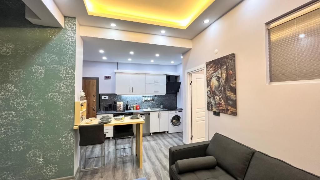 a living room with a couch and a kitchen at EGZ INSAAT REAL ESTATE in Istanbul