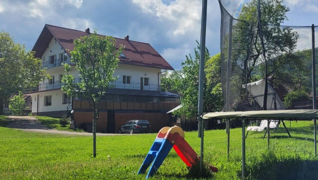 a playground in a yard in front of a house at Vila Denisa in Bran