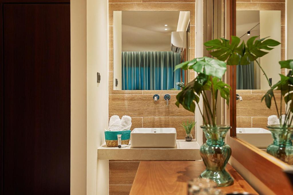 a bathroom with a sink and a mirror at Letsos Hotel in Alykes