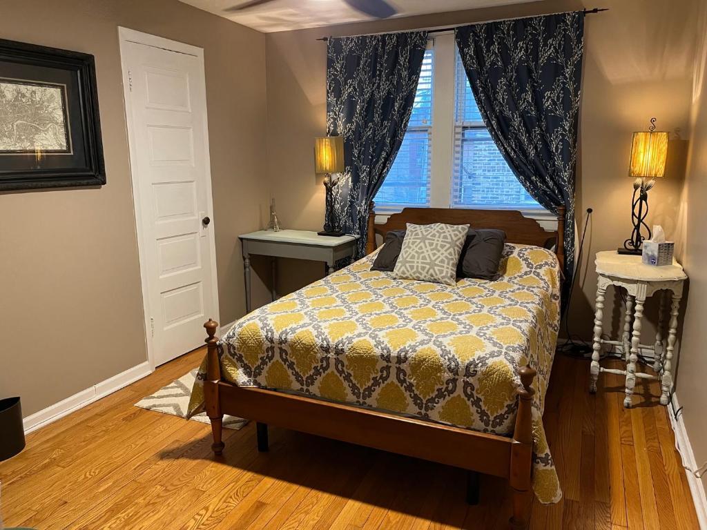 a bedroom with a bed and a window at Sunny 2 BR Apartment west of Chicago in quaint Forest Park center in Forest Park