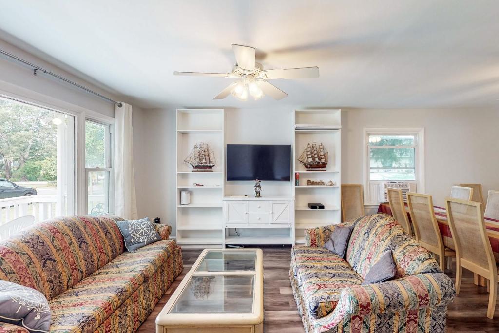 a living room with two couches and a table at Calloway Drive Retreat in Deale