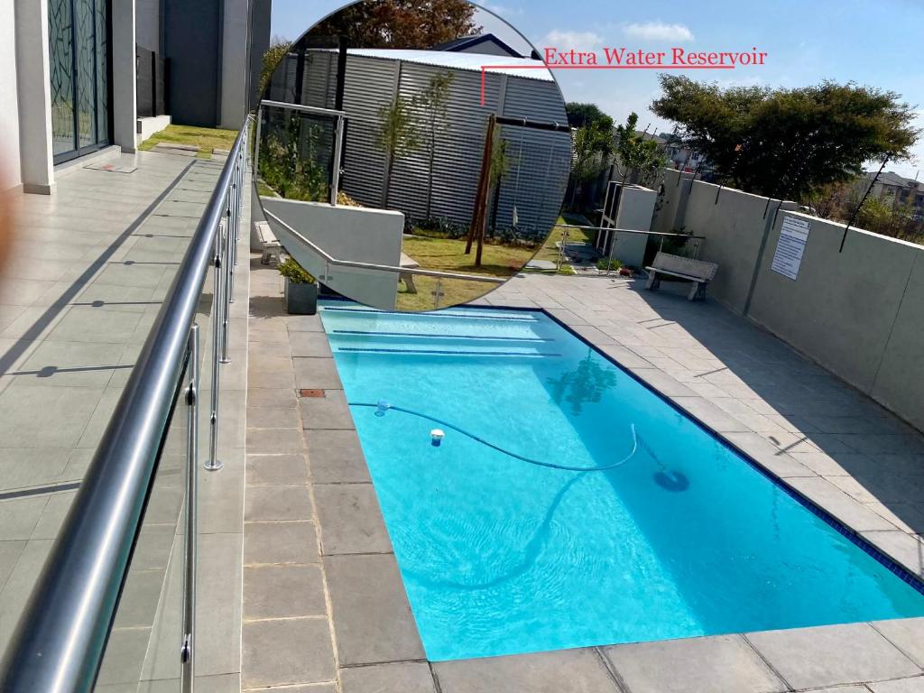 a swimming pool on the side of a house at Ladybug unit 3 (2) in Midrand