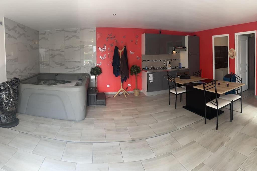 a large room with a tub and a kitchen at L'eSPAce détente in Beuvry