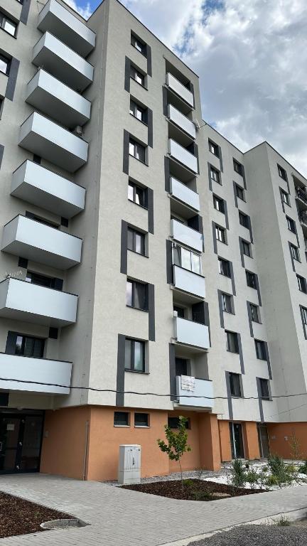 a large building with balconies on the side of it at Apartman City Park Stráňany in Michalovce