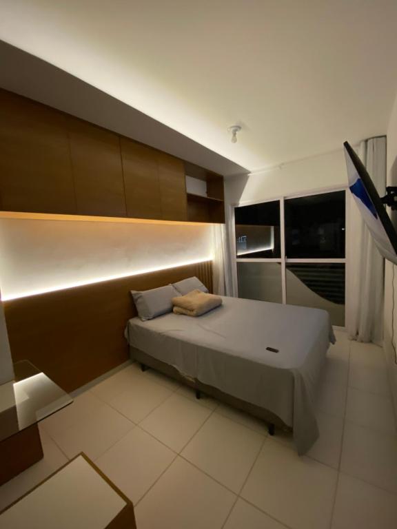 a bedroom with a large bed in a room at Flat em Campina Grande in Campina Grande