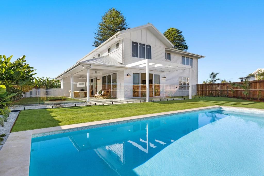 a house with a swimming pool in front of a house at Coastal Haven in North Creek