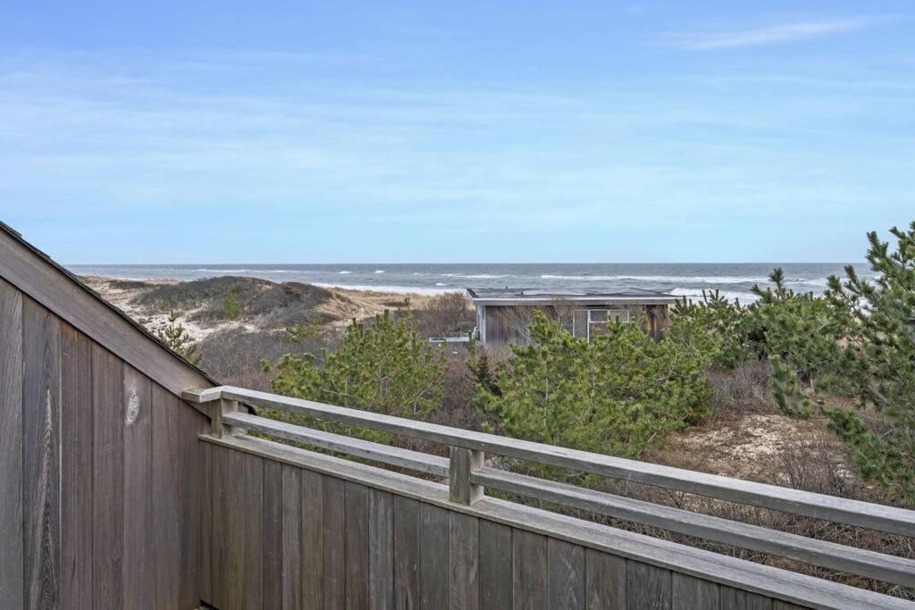 a wooden fence with the ocean in the background at Unit 1723 Ocean Colony Beach in Amagansett