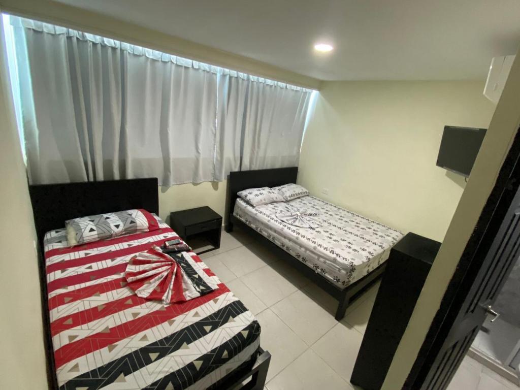 Katil atau katil-katil dalam bilik di Hotel Gloria Del Norte