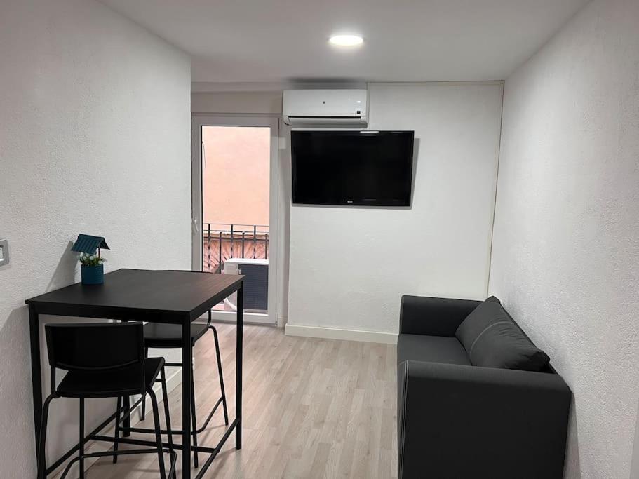 a living room with a table and a couch at Piso en el centro de Monistrol de Montserrat in Monistrol