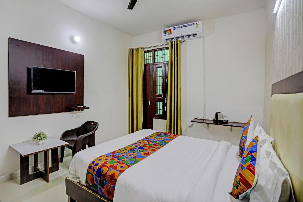 a hotel room with a bed and a tv at Shree Hotel in Lucknow