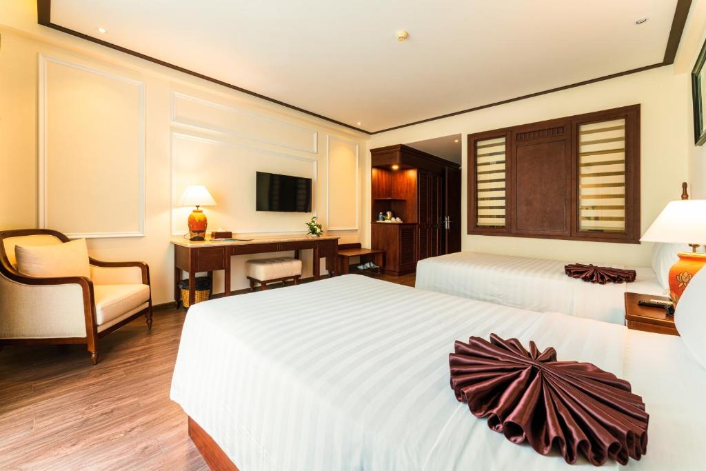 Postel nebo postele na pokoji v ubytování Tran Vien Dong Hotel