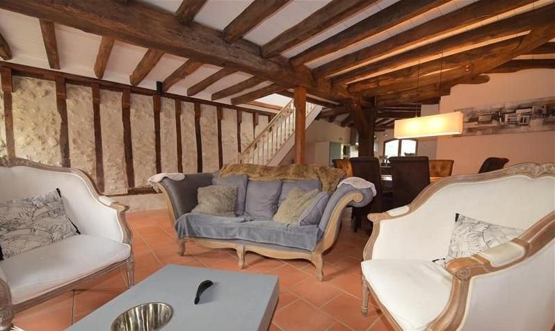 a living room with two couches and a table at MAISON DE CARACTERE COSY in Sambin