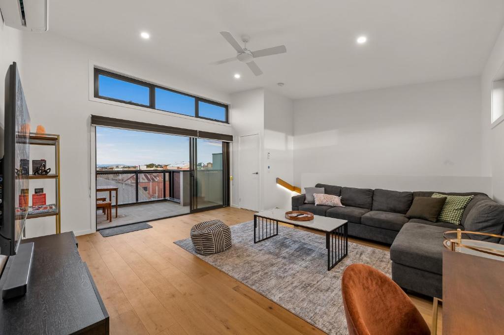 a living room with a couch and a table at StayCentral - Brunswick Central Townhouse in Melbourne