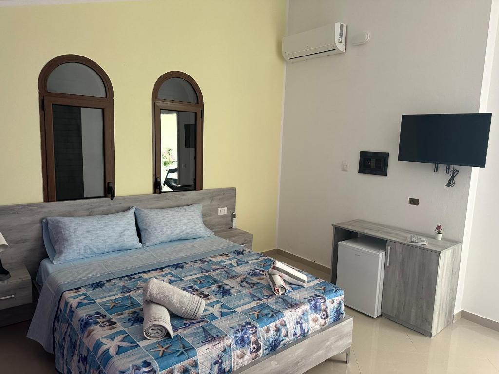 Postel nebo postele na pokoji v ubytování Hotel Anxhelo