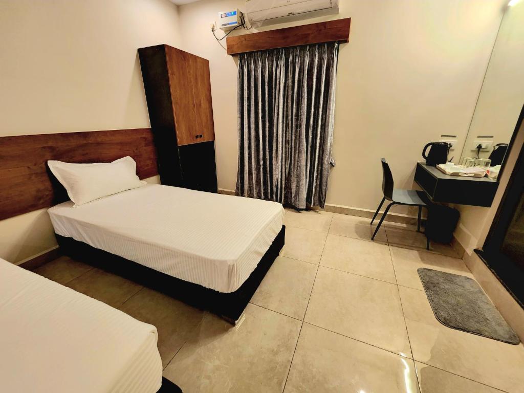 Postel nebo postele na pokoji v ubytování Hotel Park Varaahi