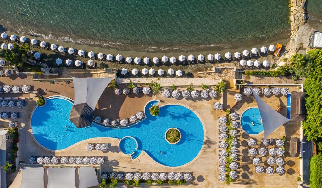 an overhead view of a pool at a resort at Royal Apollonia by Louis Hotels in Limassol