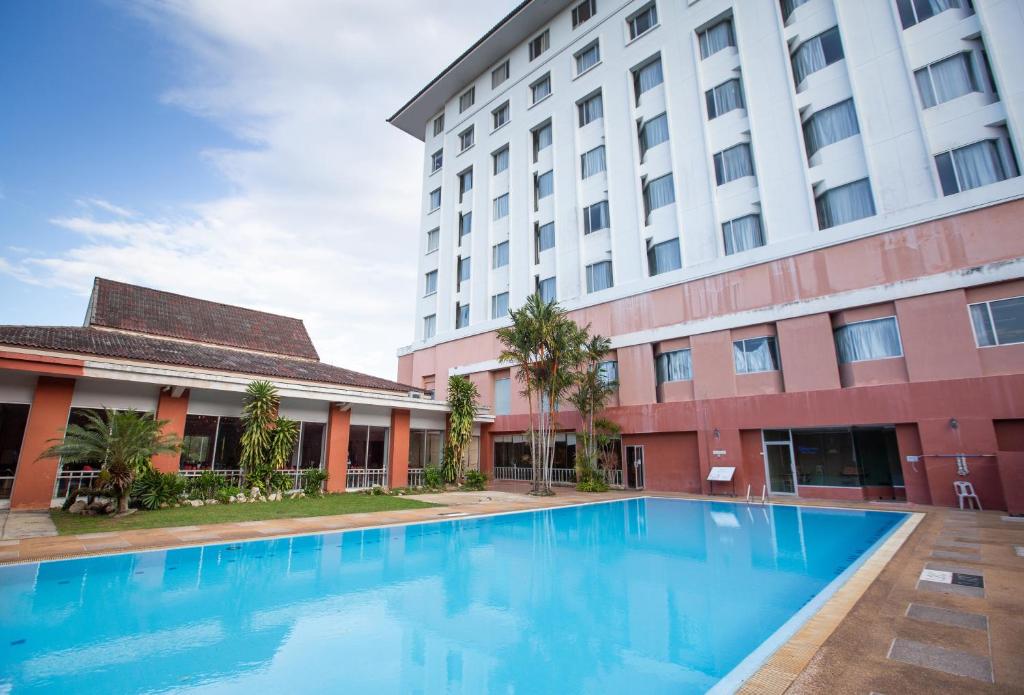 a swimming pool in front of a building at The Imperial Narathiwat Hotel in Narathiwat