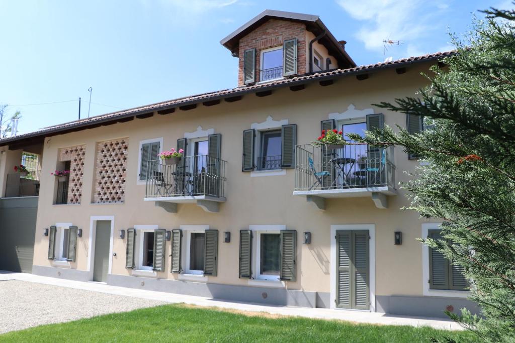 a house with green shutters and a balcony at Affittacamere Valèt in San Marzano Oliveto