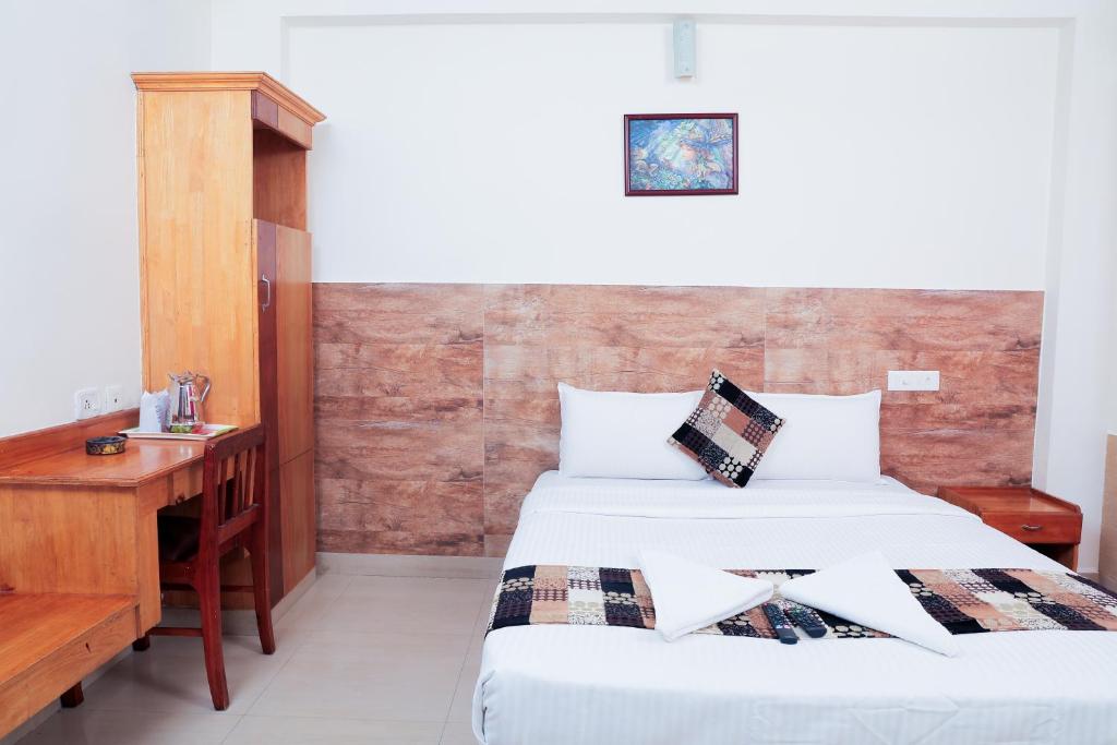 Postel nebo postele na pokoji v ubytování A V Residency