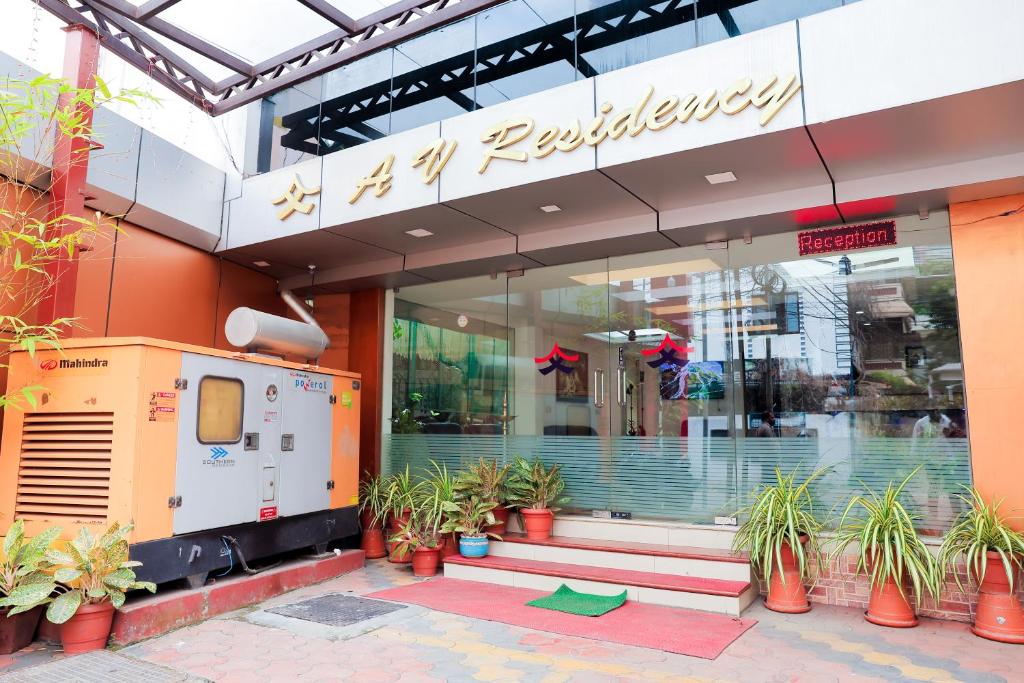 a store front with potted plants in front of it at A V Residency in Cochin