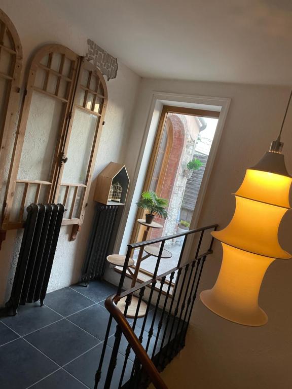 a yellow lamp sitting on the side of a room at Hôtel de la Pinède in Juan-les-Pins