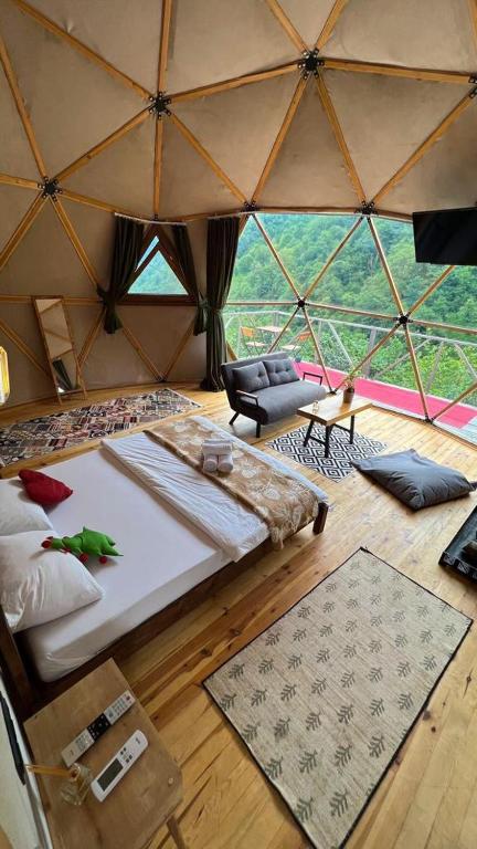 a large room with a bed in a yurt at North Dome Suite Bungalov in Rize