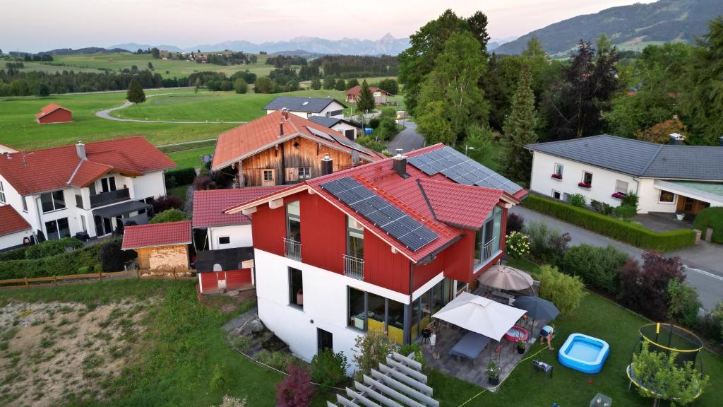 an aerial view of a house with solar panels on its roofs at Ferienwohnung Alpenglück hoch3 in Oy-Mittelberg