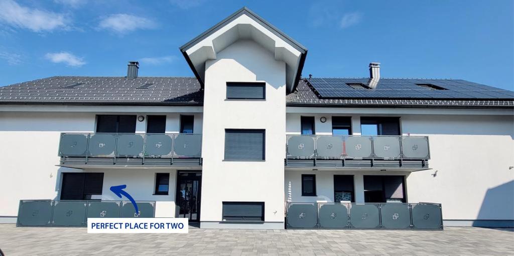 a white building with a balcony on the side of it at Perfect Place for two in Kranj