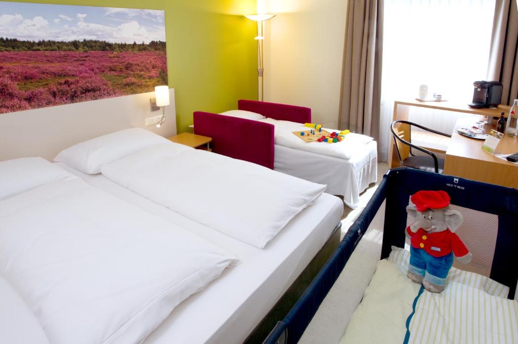 Postel nebo postele na pokoji v ubytování Anders Hotel Walsrode