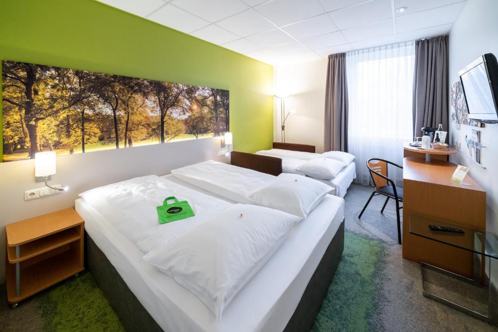 Postel nebo postele na pokoji v ubytování Anders Hotel Walsrode