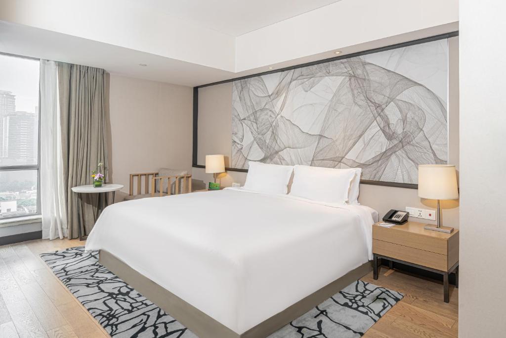 Postel nebo postele na pokoji v ubytování Riverdale Residence Xintiandi Shanghai
