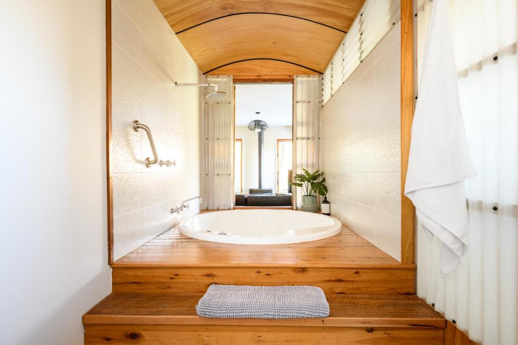 a bathroom with a large tub in a room at Azidene House & Spa Apartment in Daylesford