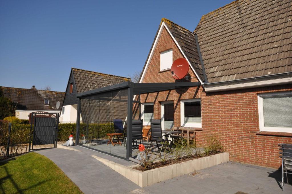 uma extensão de uma casa com um pátio em Nr 31 - Ferienhaus Am Yachthafen em Carolinensiel