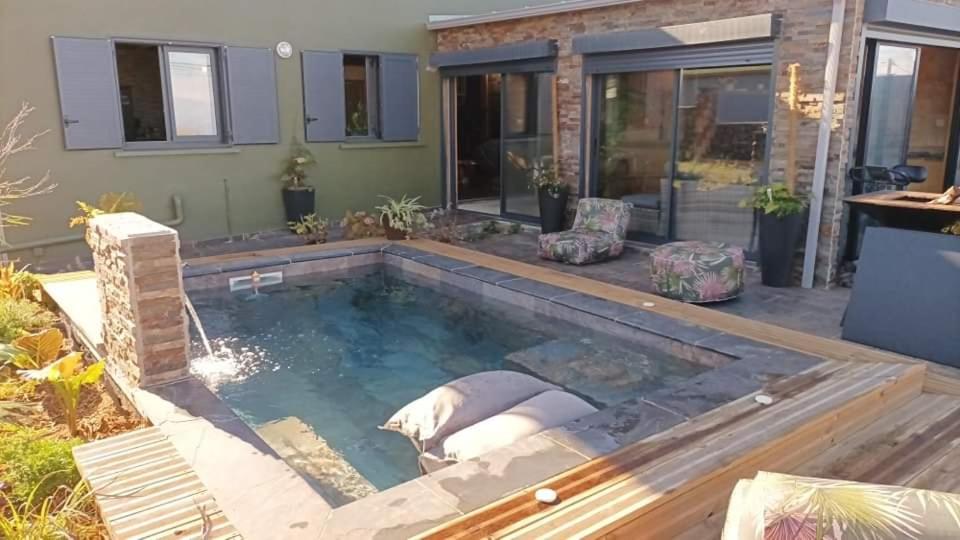 a pool in the backyard of a house at LA VIE LA Bien Être GG in Le Tampon