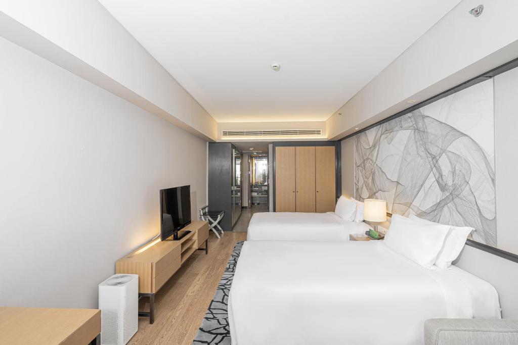 Postel nebo postele na pokoji v ubytování Riverdale Residence Xintiandi Shanghai
