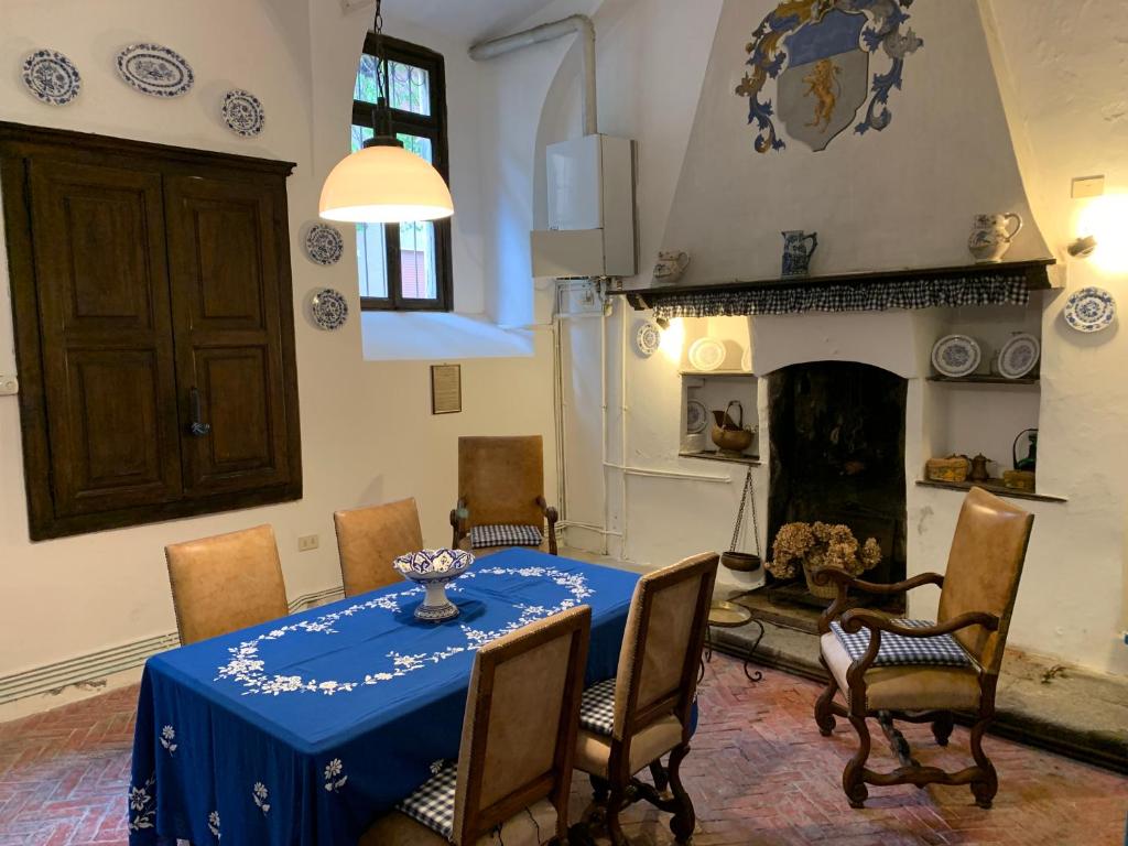 a dining room with a table and chairs and a fireplace at Case Vacanze La CORTE in Orta San Giulio