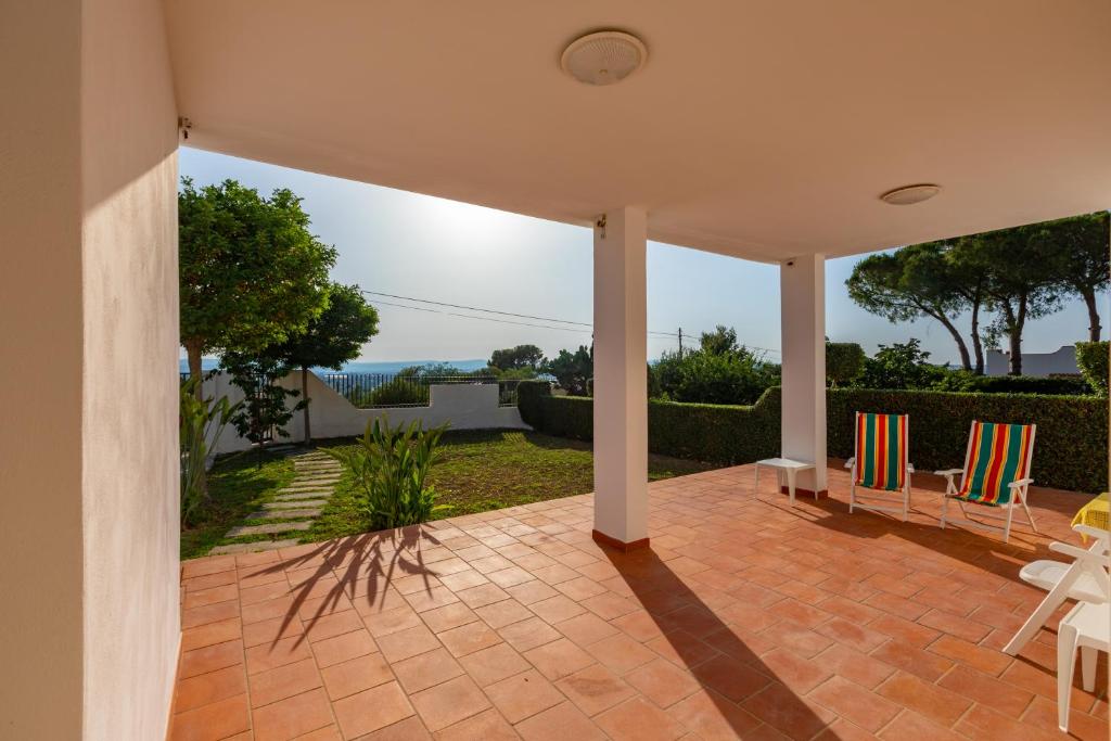 a house with a patio with chairs on it at L'isola di Gianni by Ortigia Apartments in Plemmirio