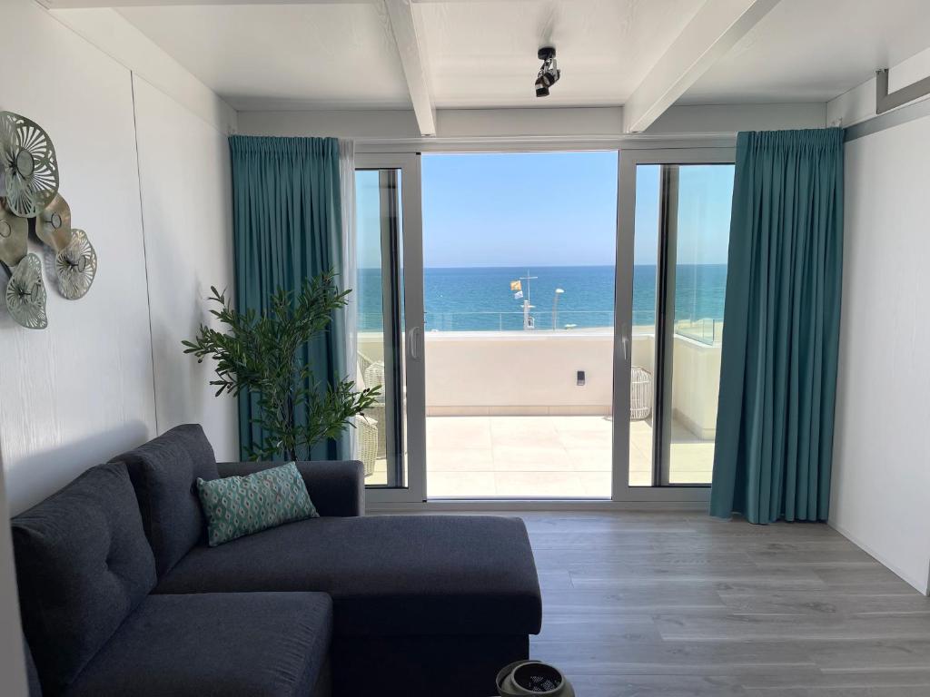 a living room with a couch and a view of the ocean at Villa Dru in Roquetas de Mar