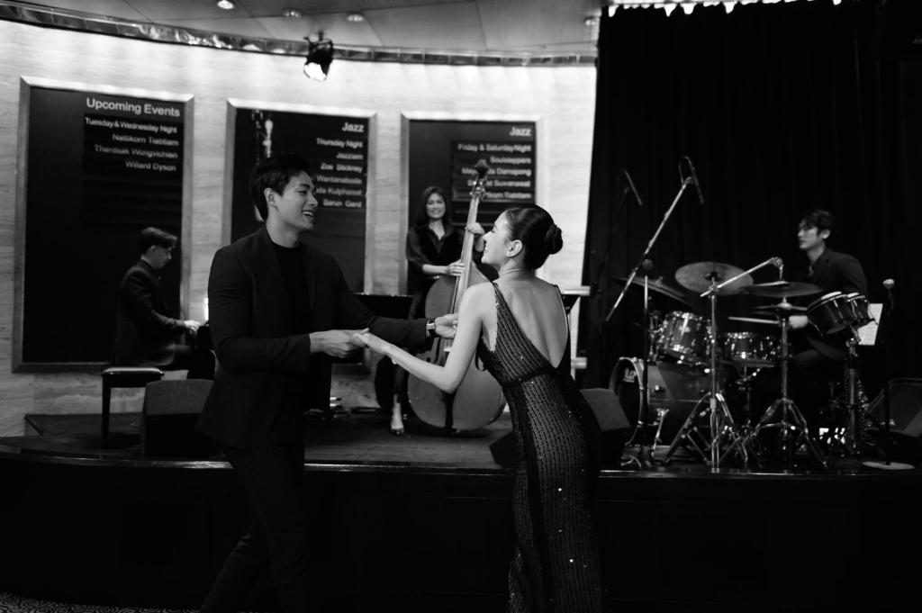 a man and a woman standing in front of a band at Sheraton Grande Sukhumvit, a Luxury Collection Hotel, Bangkok in Bangkok