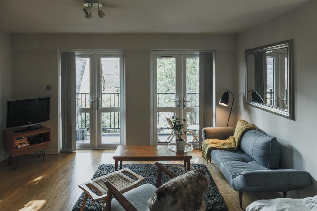 a living room with a couch and a table at Stylish Central London Flat with Pool and Terrace in London