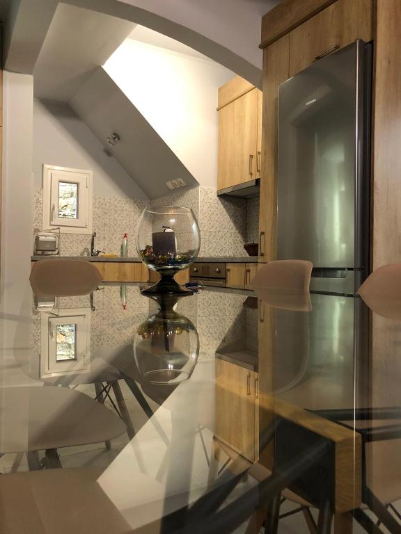 a kitchen with a glass table and some chairs at Casa del sogno in Magouládes