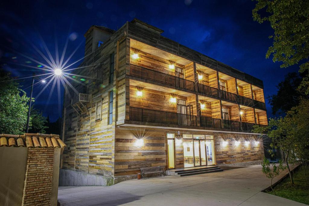 a brick building with lights on it at night at Ethno Sazano Hotel in Sazano