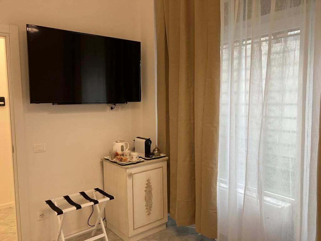 a flat screen tv hanging on a wall next to a window at Althea in Viareggio