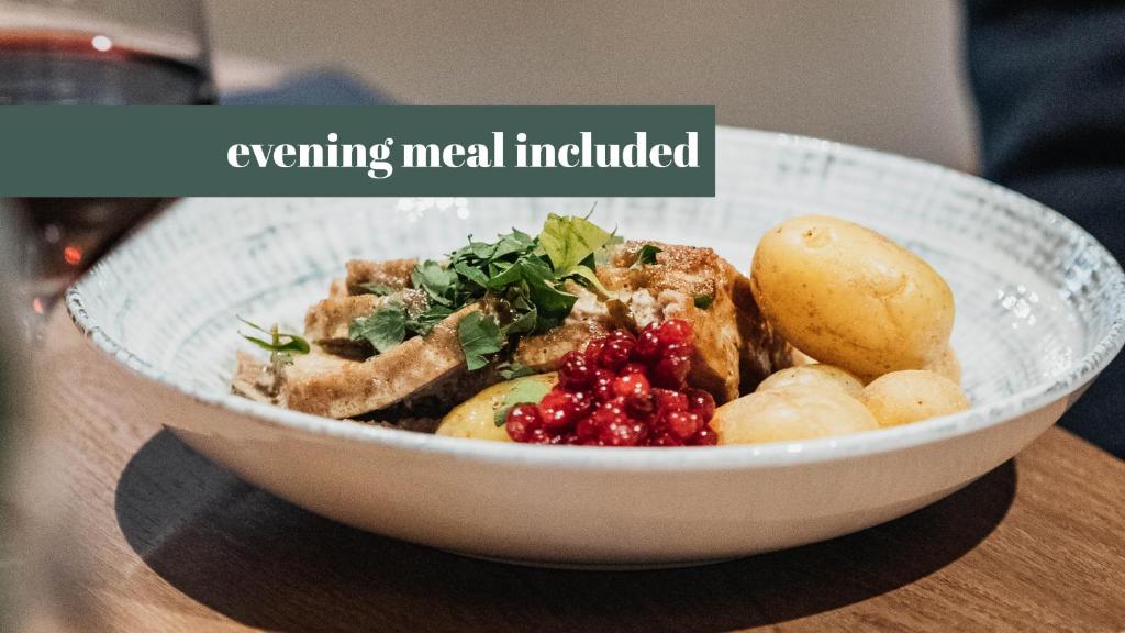 a white bowl of food on a wooden table at Clarion Collection Hotel Bryggeparken in Skien