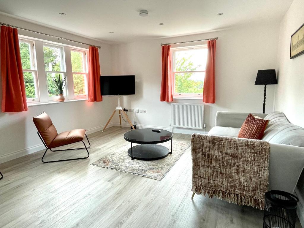 a living room with a couch and a table at Stylish Central Reading Apartment - Free Parking in Reading